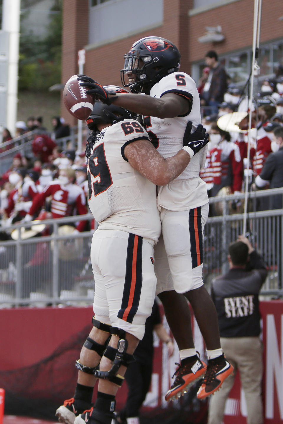 Oregon State running back Deshaun Fenwick (5) celebrates his touchdown with offensive lineman Nous Keobounnam (69) during the second half of an NCAA college football game against Washington State, Saturday, Oct. 9, 2021, in Pullman, Wash. Washington State won 31-24. (AP Photo/Young Kwak)