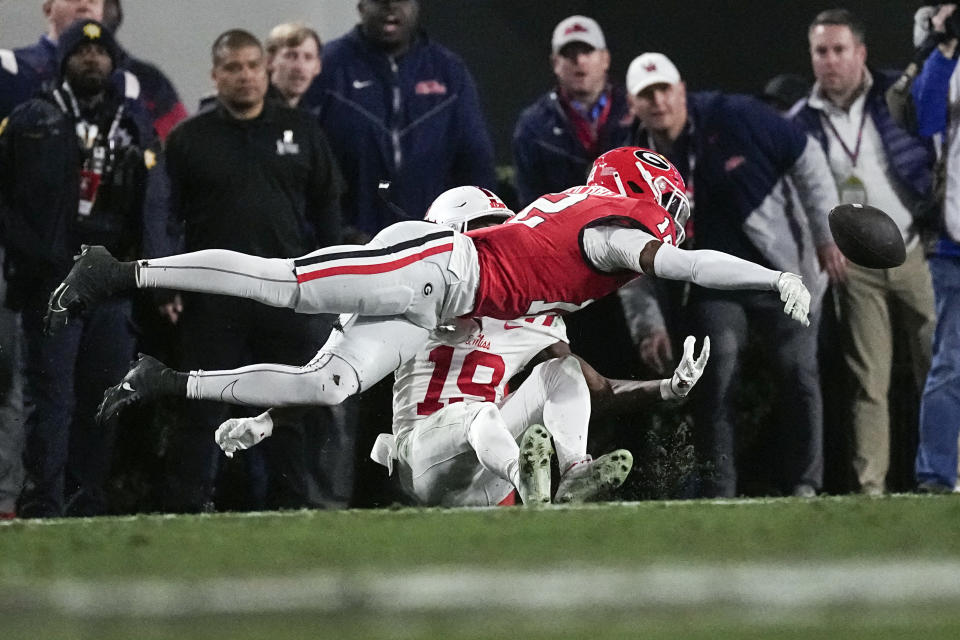 Georgia defensive back Julian Humphrey (12) is called for pass interference as he breaks up a pass intended for Mississippi wide receiver Dayton Wade (19) during the first half of an NCAA college football game, Saturday, Nov. 11, 2023, in Athens, Ga. (AP Photo/John Bazemore)