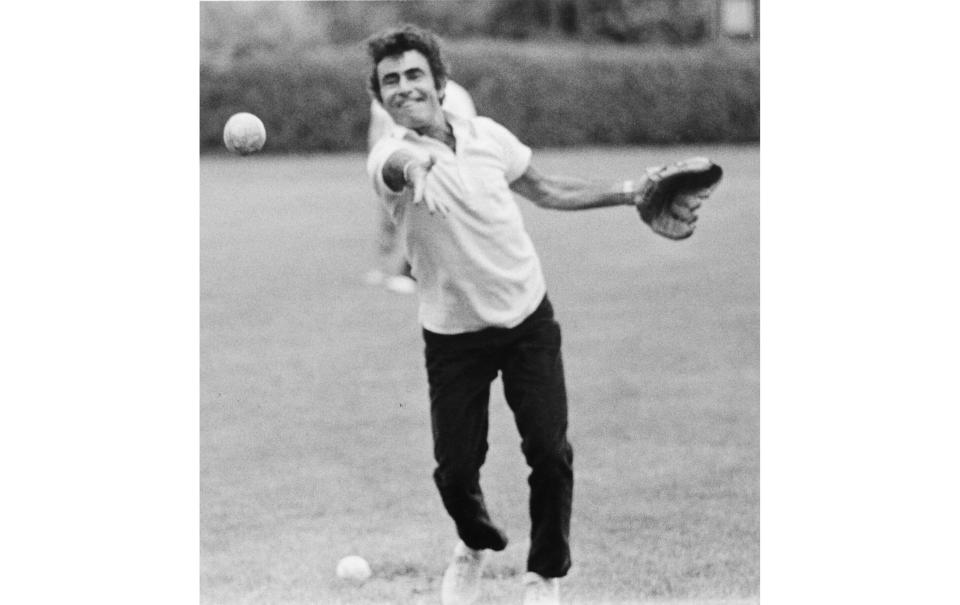 This 1973 family photo provided by Anne Serling shows her father, television writer Rod Serling tossing a softball at a school his daughter attended, in Massachusetts. Years before he journeyed to "The Twilight Zone," Rod Serling made a brief detour to the strike zone, writing a comedy about baseball. (Courtesy of Anne Serling via AP)