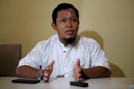 Agus Junaedi, who took over the vigilante wing of Team Hisbah after the death of its founder Sigit in 2011, gestures during an interview with Reuters in Solo, Indonesia Central Java province, August 10, 2016. Picture taken August 10, 2016. REUTERS/Beawiharta