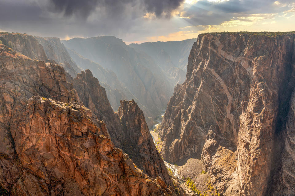 An ominous dark cloud looms over the Black Canyon of Gunnison National Park.