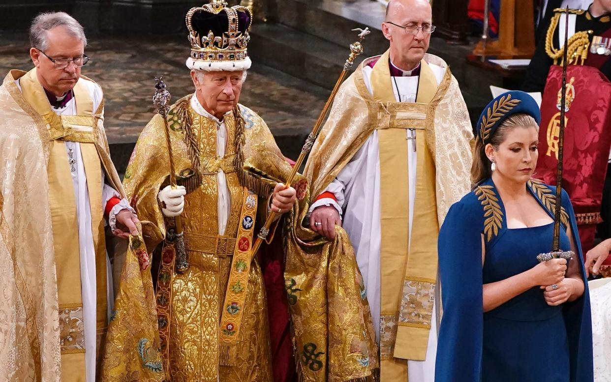 Penny Mordaunt leads King Charles III wearing the St Edward's Crown - Getty Images Europe