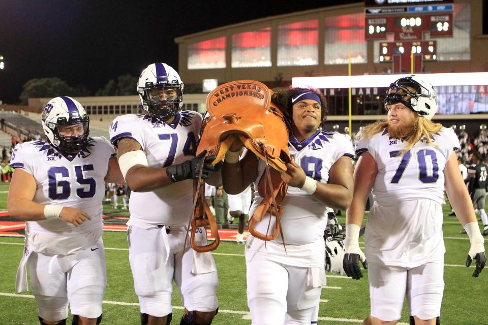 TCU players carry off The Saddle after the Horned Frogs beat Texas Tech 52-31 last year in Jones AT&T Stadium. The two teams vie for the traveling trophy again Saturday at Amon Carter Stadium in Fort Worth.