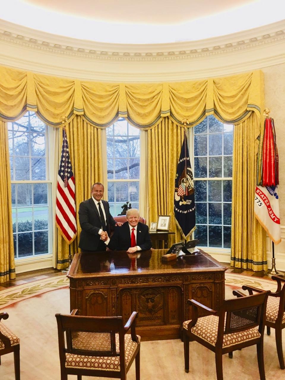 This image from the website of Allied Wallet CEO Ahmad "Andy" Khawaja shows Khawaja posing with President Donald Trump in the Oval Office of the White House in Washington. Khawaja gave more than $4 million to Hillary Clinton’s failed presidential campaign and other Democrats, then began extending his largesse to Republicans after a lunch with GOP fundraiser Elliott Broidy two weeks after Trump clinched the presidency. Records obtained by The Associated Press show that Khawaja has helped pornographers, payday loan debt collectors and offshore gambling operations get past the gates of the banking system.(Andy Khawaja via AP)
