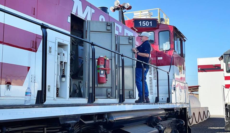 Jared Martin, vice president for operations at the Modesto & Empire Traction Co., examines one of the locomotives that will get a low-polluting engine as part of a $12.2 million federal grant. He discussed it at the Modesto, California, headquarters on July 28, 2023.