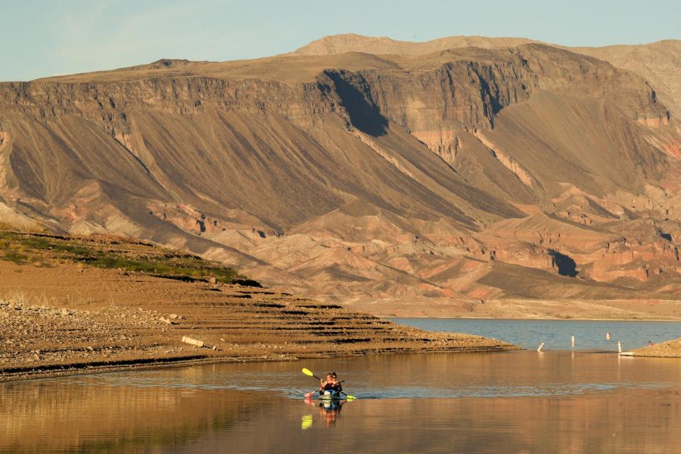 Kayakers make their way through a shallow stretch of Lake Mead