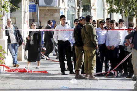 Israeli soldiers secure the area after a stabbing attack by two Palestinian women took place in central Jerusalem, November 23, 2015. REUTERS/Ammar Awad