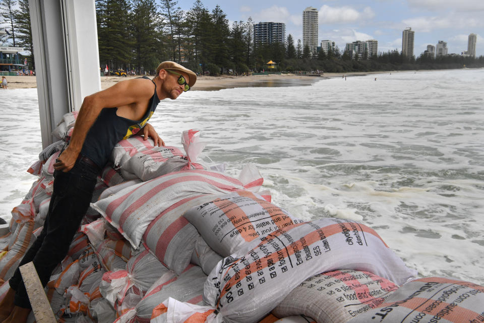 A restaurant staff member is seen sandbagging at Burleigh Heads, Queensland.