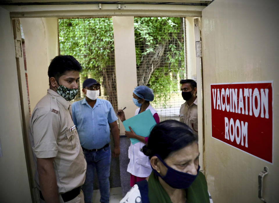 People arrive to get inoculated in New Delhi, India, Monday, April 5, 2021. India’s daily confirmed coronavirus cases have recorded the biggest single-day spike since the pandemic began, indicating a renewed crush of infections. The government has intensified its vaccination drive in recent weeks, now administering over 3 million jabs a day. (AP Photo/Manish Swarup)