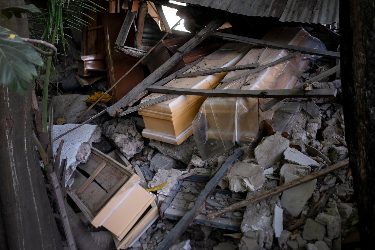 Coffins lay in the debris of a collapsed store that sold coffins in Saint-Louis-du-Sud, Haiti on Monday, Aug. 16, 2021.