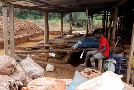 A young informal gold miner rests at the site of Nsuaem-Top