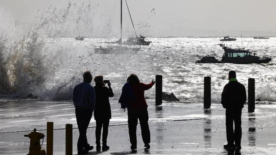 Wind-driven waves crash at south-facing Port San Luis during a break in the clouds on Tuesday, March 21, 2023. Admiring the power of the Pacific Ocean are, from left, Joel, Jeanne Gilmore, Jennifer and Rick Gilmore. Joel and Jennifer declined to give their last names. David Middlecamp/dmiddlecamp@thetribunenews.com