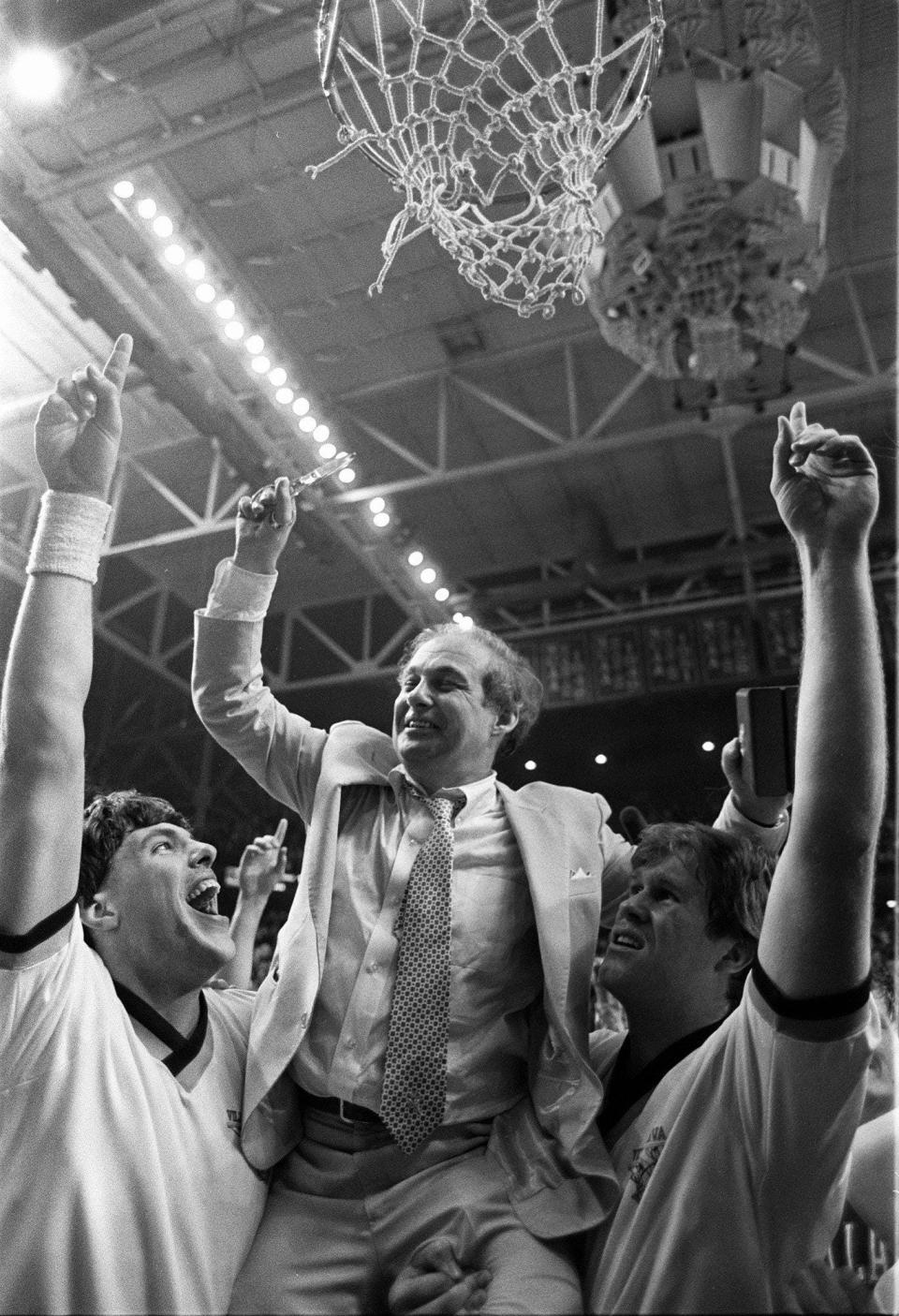 Villanova coach Rollie Massimino is boosted aloft to cut the net down after they won they upset Georgetown in the 1985 national championship game.