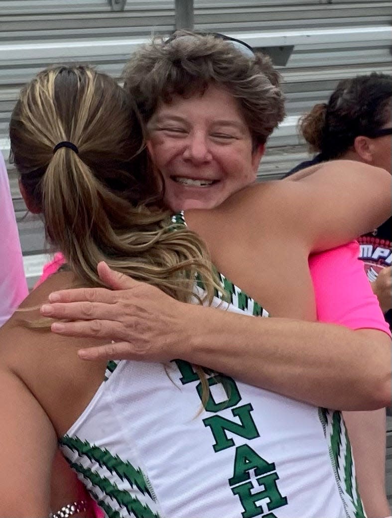 Valerie Hunt of Monahan receives a hug from Sara Bush after the pole vault event on Thursday. The Hunt and Bush families plan to get together during summer vacation.