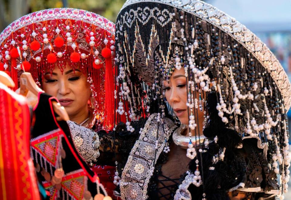 Ker Lee, left, and Chia Her of Sacramento do some shopping as thousands of Hmong community members gathered at Cal Expo this weekend to celebrate the Sacramento Hmong New Year festival Saturday.