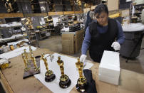 CHICAGO, IL - FEBRUARY 09: Josefina Govea packages an Oscar statuette at R.S. Owens & Company February 9, 2012 in Chicago, Illinois. R.S. Owens manufactures the Oscar statuettes which are presented at the annual Academy Awards by the Academy of Motion Picture Arts and Sciences. After the theft of the statuettes prior to the 2000 Academy Awards the company began casting the statuettes one year in advance of the show. (Photo by Scott Olson/Getty Images)