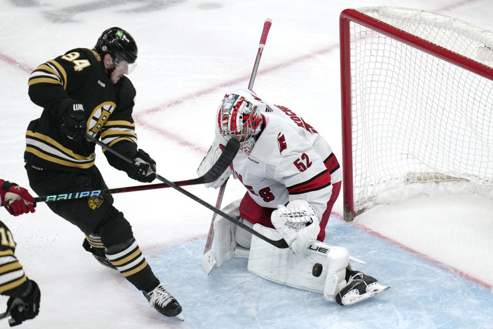 Carolina Hurricanes goaltender Pyotr Kochetkov (52) makes the save on a shot by Boston Bruins center Jakub Lauko (94) during the third period of an NHL hockey game, Tuesday, April 9, 2024, in Boston. (AP Photo/Charles Krupa)