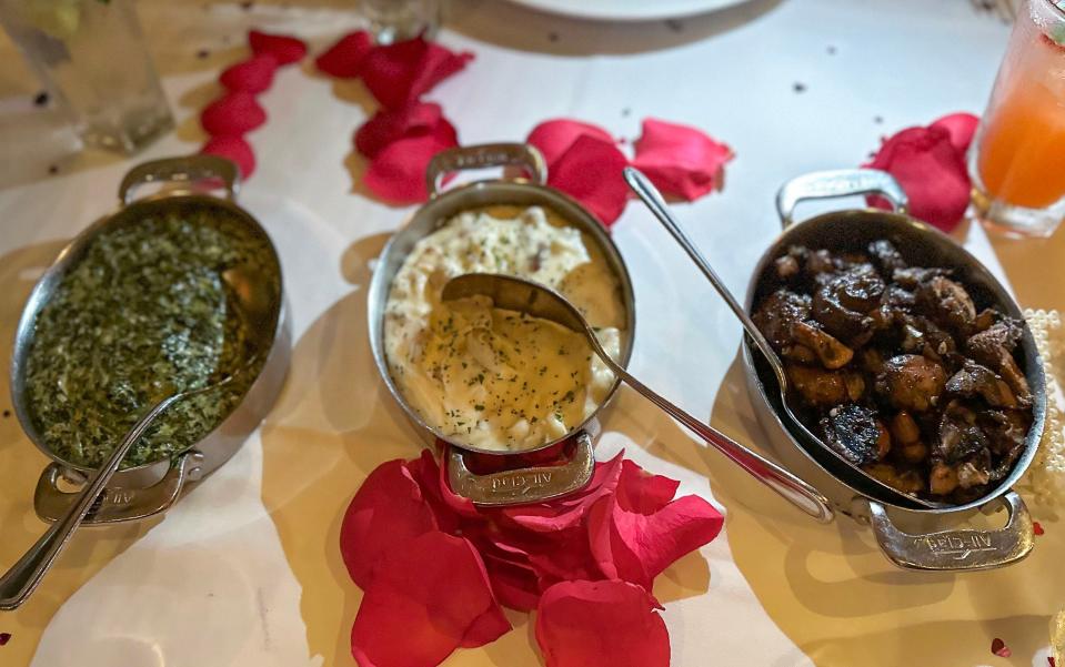 Three metal bowls of side dishes at  Capital Grille 