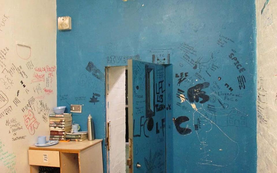 Inside a cell covered in graffiti in the Victorian prison - PA