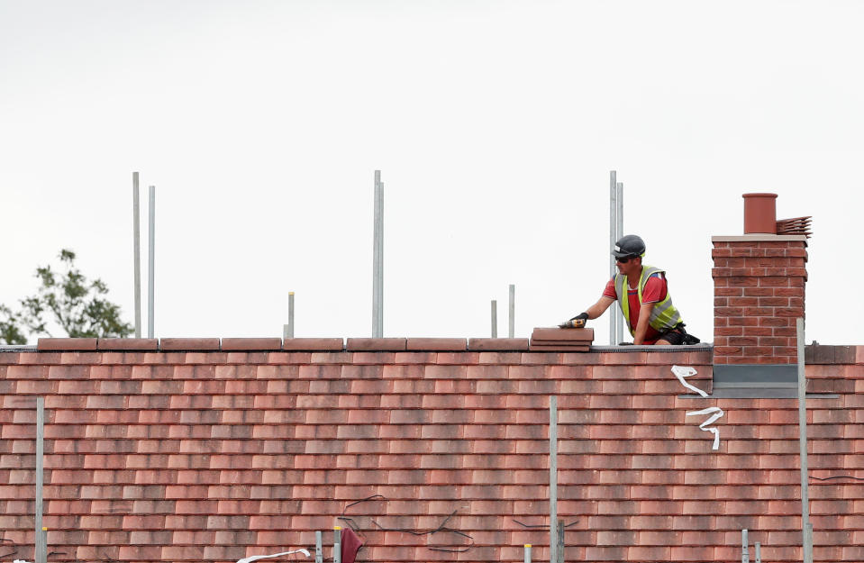 A construction worker builds a new house in Berkhamsted, Britain. Photo: Matthew Childs/Reuters