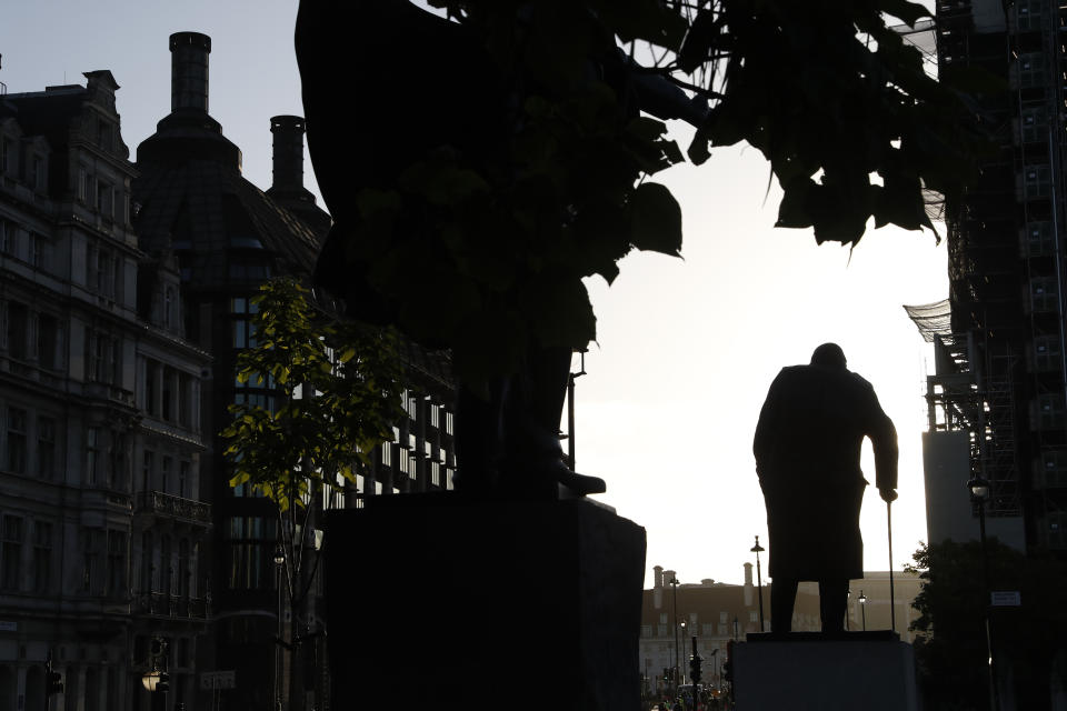 The statue of former British Prime Minister Winston Churchill is silhouetted against the sky early morning in London, Thursday, Sept. 12, 2019. (AP Photo/Alastair Grant)
