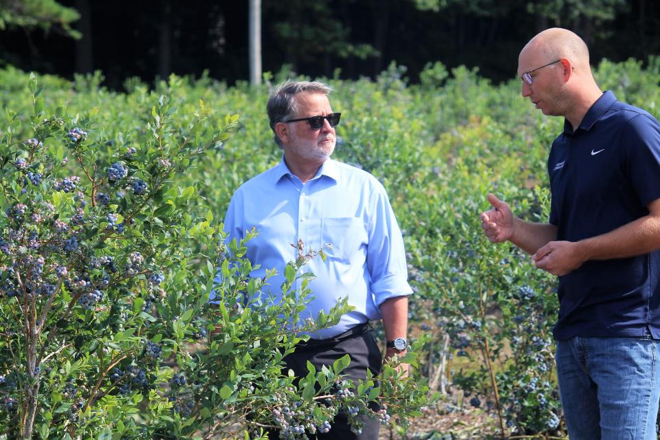 Michigan Sen. Gary Peters speaks with Luke DeHaan of Crossroads Blueberry Farm in West Olive on Friday, July 14, 2023.