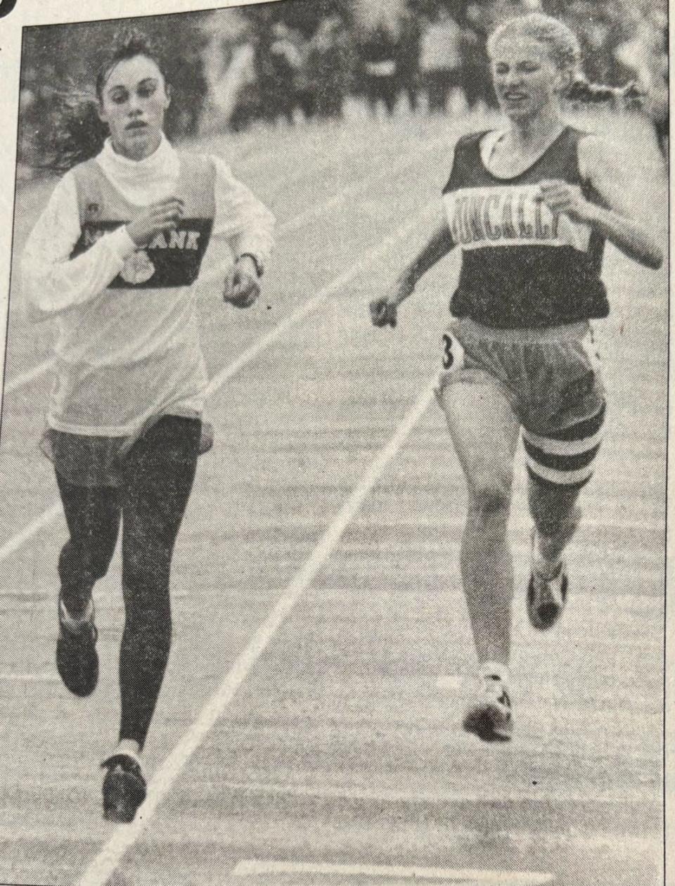 Jaime Pauli of Milbank (left) and Meg Larson of Aberdeen Roncalli battle to the finish in the Class A girls' 1,600-meter run during the 1995 South Dakota State High School Track and Field Championships.