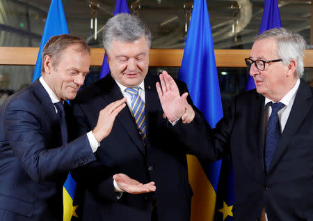 FILE PHOTO: Ukraine's President Petro Poroshenko is welcomed by President of the European Council Donald Tusk and European Commission President Jean-Claude Juncker at the Europa building in Brussels, Belgium March 20, 2019. Frank Augstein/Pool via REUTERS/File Photo