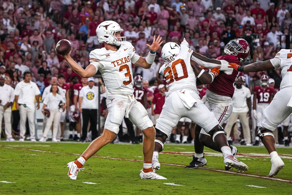 Texas quarterback Quinn Ewers steps up into the pocket during the Longhorns' 34-24 win at Bryant-Denny Stadium in Tuscaloosa, Ala., on Saturday. Ewers didn't suffer a single sack while throwing for 349 yards and three touchdowns.