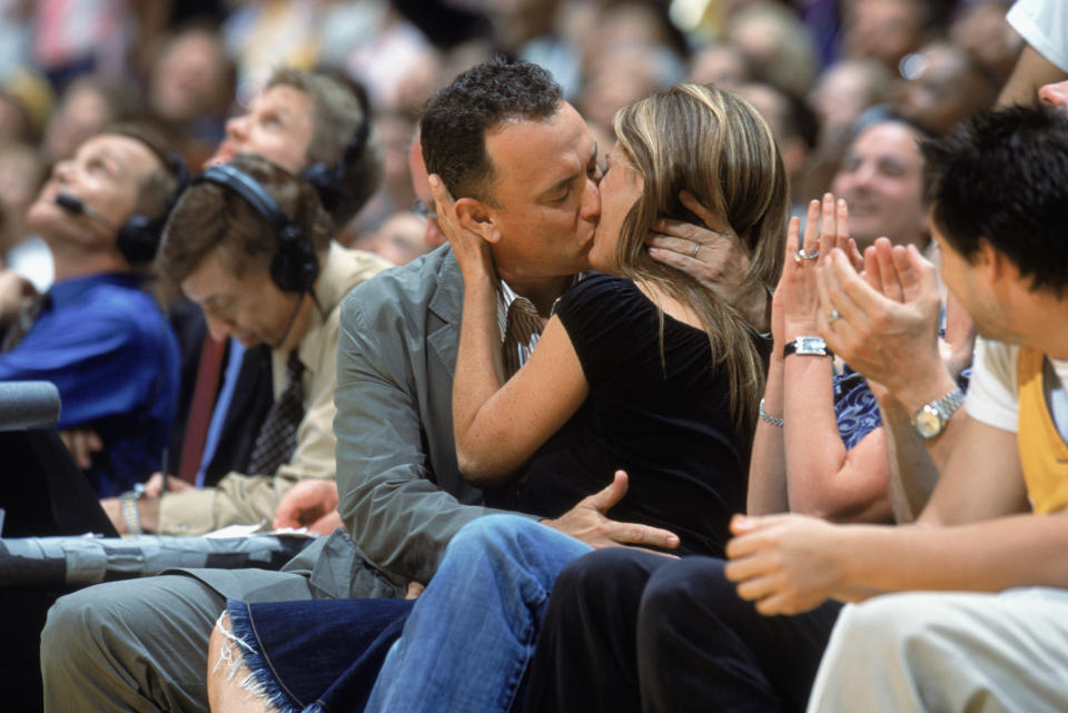 Hanks and Wilson share a kiss courtside at a 2004 Los Angeles Lakers game. (Photo: Andrew D. Bernstein /NBAE via Getty Images)