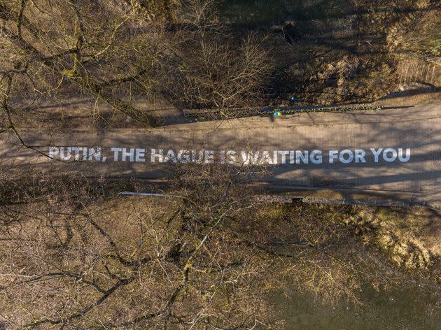 A sign that reads “Putin, The Hague is waiting for you” is seen outside the Russian embassy in Vilnius, the capital of Lithuania. (Photo: Handout via Reuters)