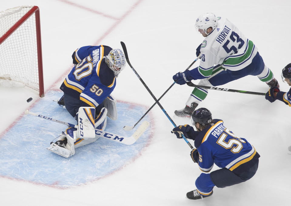 Vancouver Canucks' Bo Horvat (53) scores on St. Louis Blues goalie Jordan Binnington (50) as Blues' Colton Parayko (55) defends during the first period of an NHL hockey Stanley Cup first-round playoff series, Friday, Aug. 14, 2020, in Edmonton, Alberta. (Jason Franson/The Canadian Press via AP)