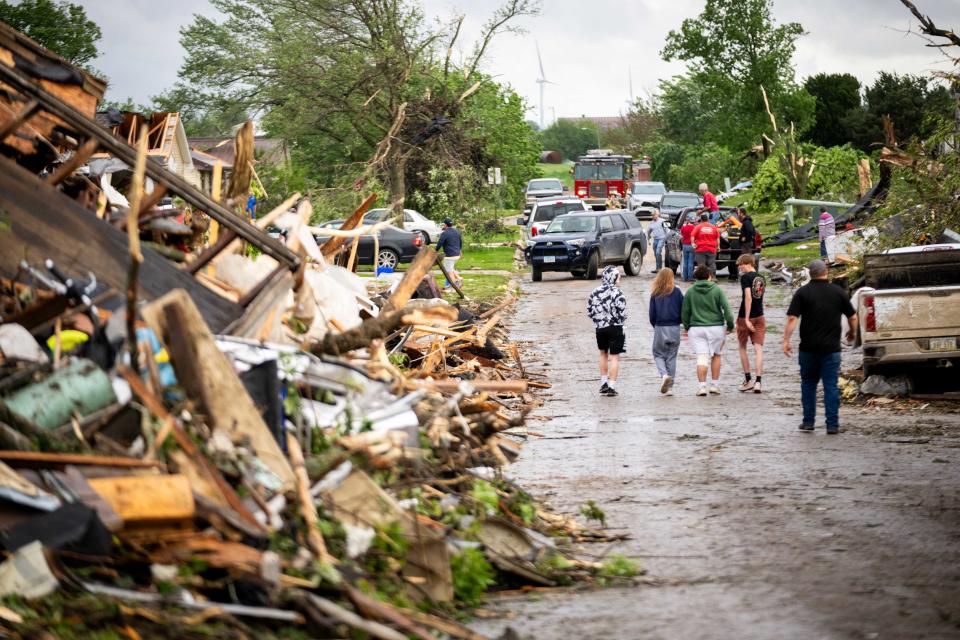 People begin clean up after a powerful tornado hit Greenfield on Tuesday, May 21, 2024.