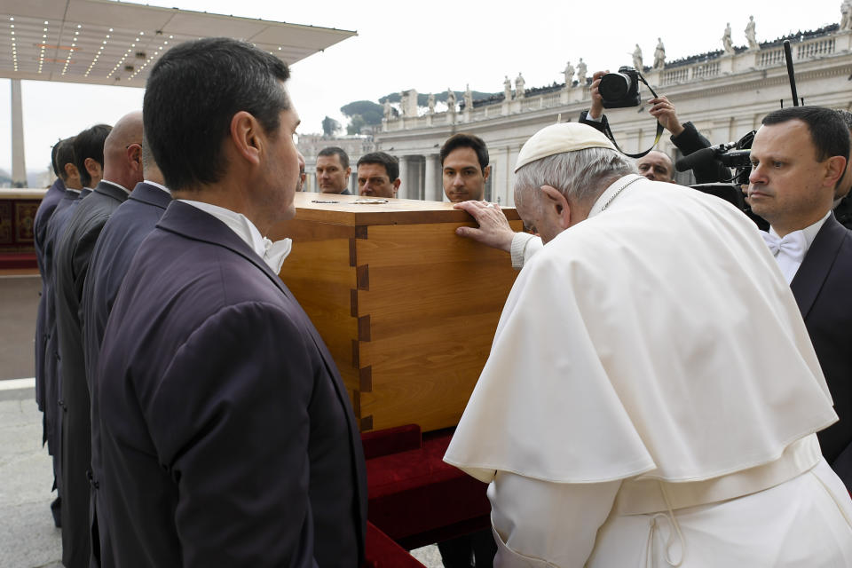 In this image released on Thursday, Jan. 5, 2023, by the Vatican Media news service, Pope Francis touches the coffin of late Pope Emeritus Benedict XVI after the funeral mass for late Pope Emeritus Benedict XVI in St. Peter's Square at the Vatican, Thursday, Jan. 5, 2023. Benedict died at 95 on Dec. 31 in the monastery on the Vatican grounds where he had spent nearly all of his decade in retirement. He was 95. (Vatican Media via AP)