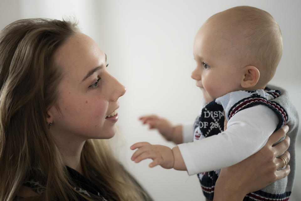 Vlada Yushchenko, a 19-year-old Ukrainian refugee, holds her son Daniel, during an interview with The Associated Press in Brasov, Romania, Thursday, Feb. 2, 2023. Yushchenko was still in her teens and nearly three months pregnant when she hugged her husband at the border, turned away and walked into Moldova. Now she’s in Romania, one of the millions of Ukrainians forced to flee Russia’s invasion of their country. Her baby, Daniel, was born there eight months ago and still hasn’t met his father Yaroslav, who is 21 and, like most men of fighting age, prohibited from leaving Ukraine. (AP Photo/Vadim Ghirda)