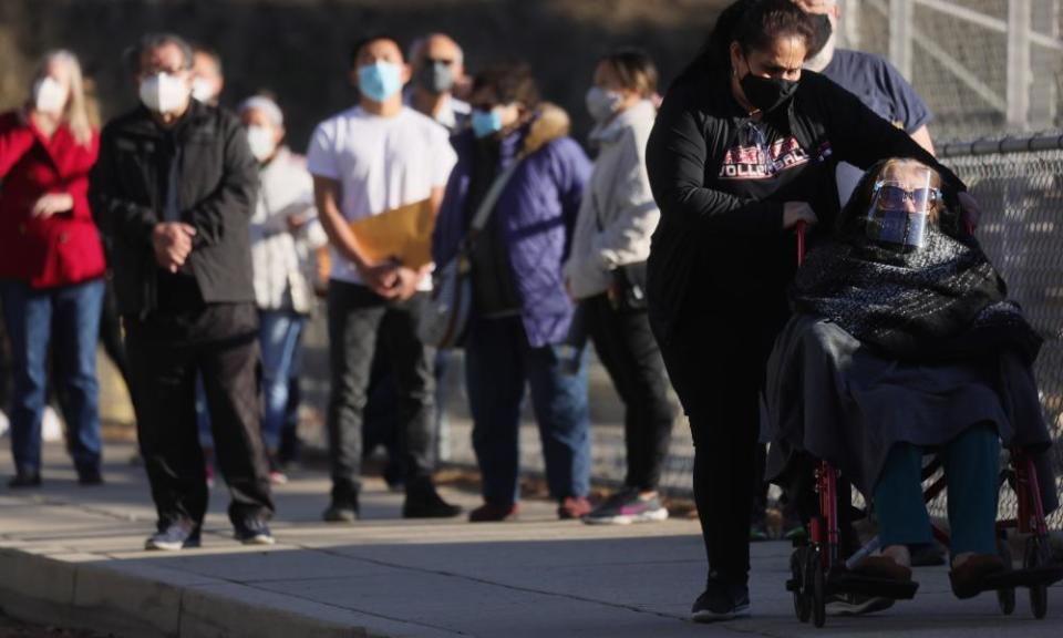 People wait in line to receive the Covid-19 vaccine on 26 January 2021 in Los Angeles, California.