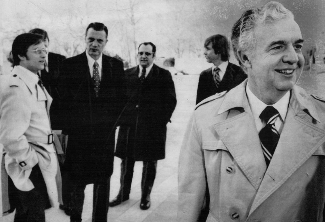 Michigan Attorney General Frank Kelley, right, stops to chat with journalists outside the Supreme Court in Washington in February 1974. Kelley and other people from Michigan went to court for a hearing on the Detroit school busing case.