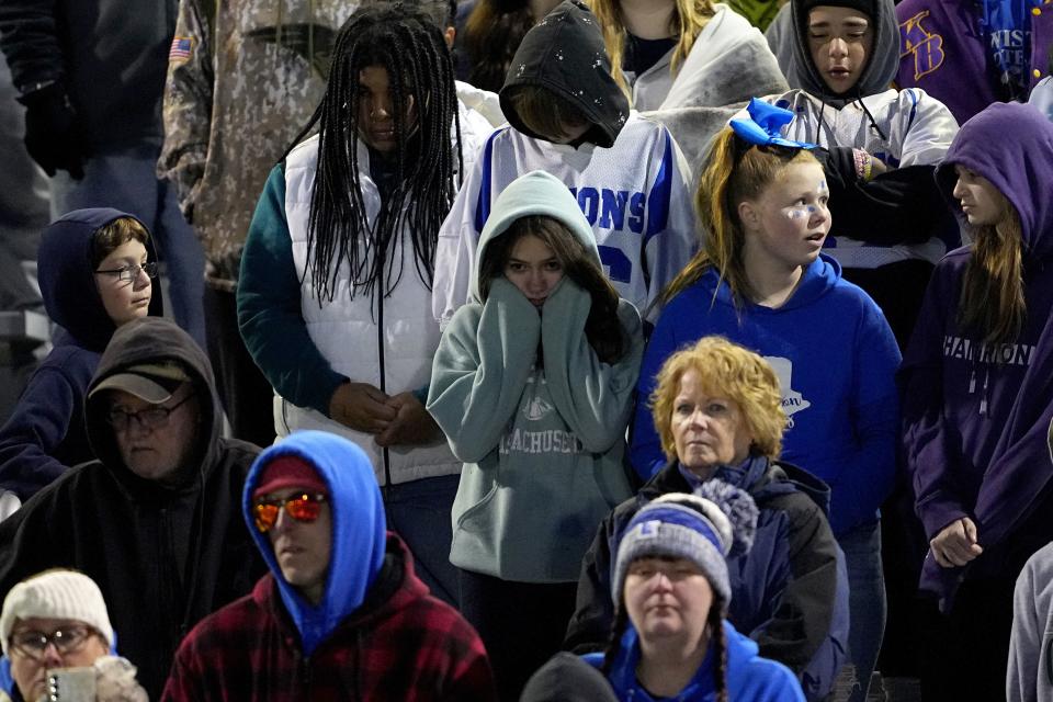 Lewiston High School fans stand during a moment of silence for the victims of the Lewiston shooting, Wednesday, Nov. 1, 2023, prior to a high school football game against Edward Little High School in Lewiston, Maine. Locals seek a return to normalcy after the mass shooting on Oct. 25. (AP Photo/Matt York)
