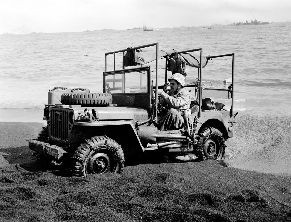 A U.S. Marine driving an ambulance jeep struggles for traction on the sandy beach at Iwo Jima during the American advance on the strategic Japanese Volcano Island stronghold on Feb. 26, 1945.