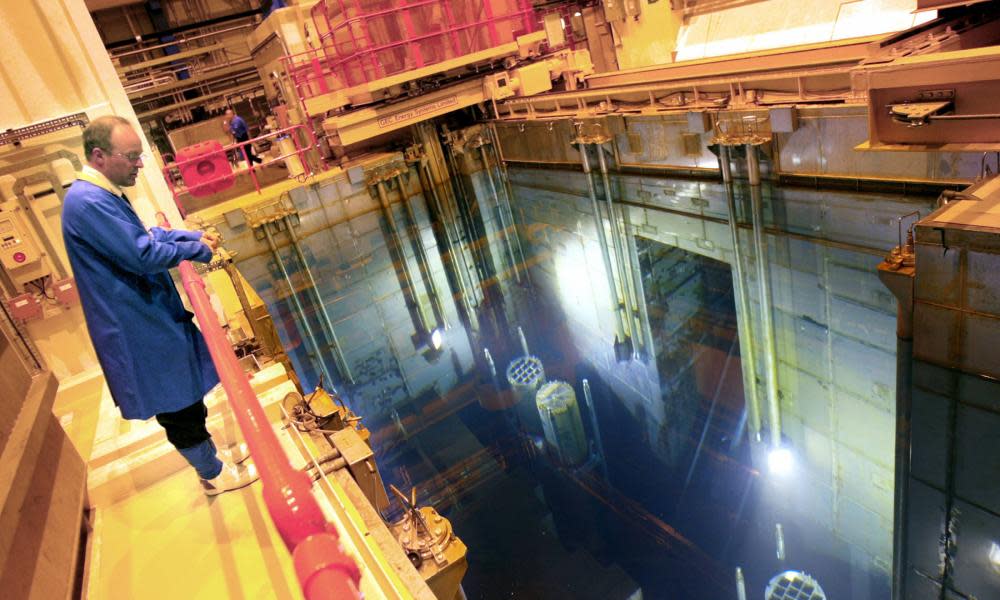 Employee stands on platform overlooking nuclear waste facility