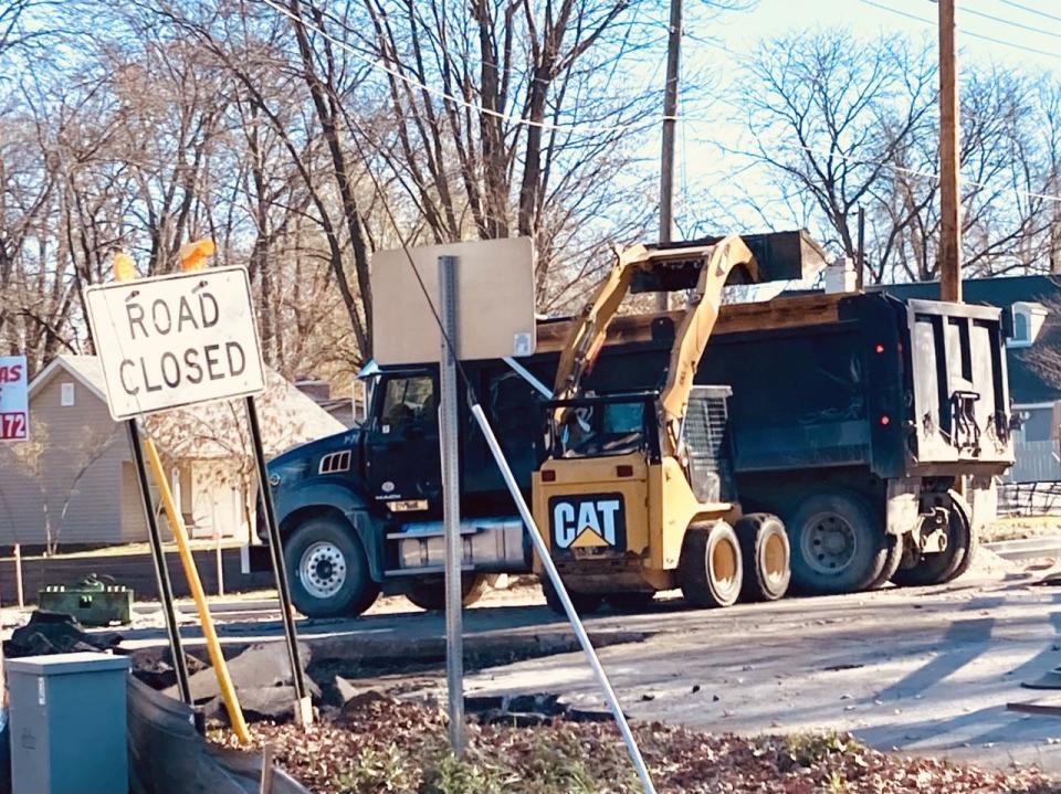 Part of Riverside Avenue pavement is dumped in the bed of a dump truck at the in intersection of Riverside and Jackson Street were work continues on the intersection and the Riverside Avenue Trail Project. Asphalt for some of the trail is expected to be laid this week.