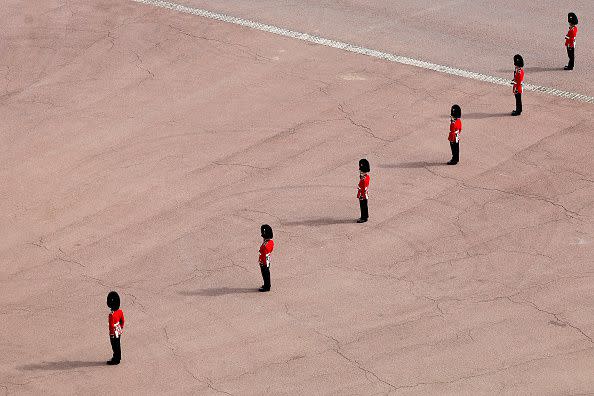 LONDON, ENGLAND - SEPTEMBER 19: Coldstream Guards in formation outside Buckingham Palace pay their respects during the State Funeral of Queen Elizabeth II on September 19, 2022 in London, England. Elizabeth Alexandra Mary Windsor was born in Bruton Street, Mayfair, London on 21 April 1926. She married Prince Philip in 1947 and ascended the throne of the United Kingdom and Commonwealth on 6 February 1952 after the death of her Father, King George VI. Queen Elizabeth II died at Balmoral Castle in Scotland on September 8, 2022, and is succeeded by her eldest son, King Charles III.  (Photo by Chip Somodevilla/Getty Images)