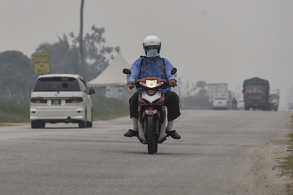 A motorcyclist travels along a road in Kampung Johan Setia in Klang September 18, 2019. — Picture by Miera Zulyana