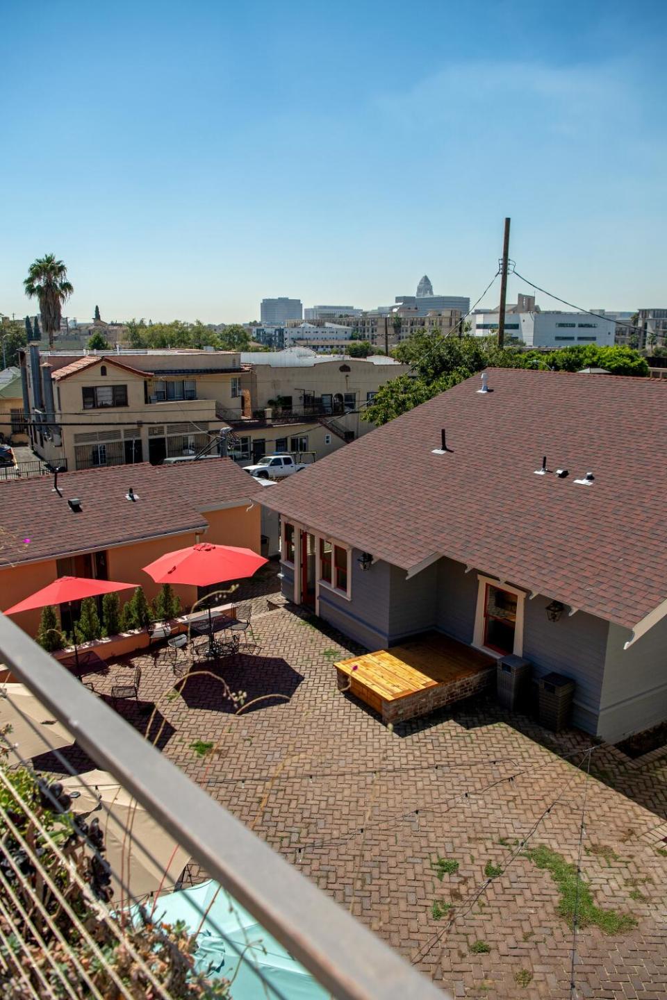 A high-angle view of a courtyard, with a city skyline in the background.