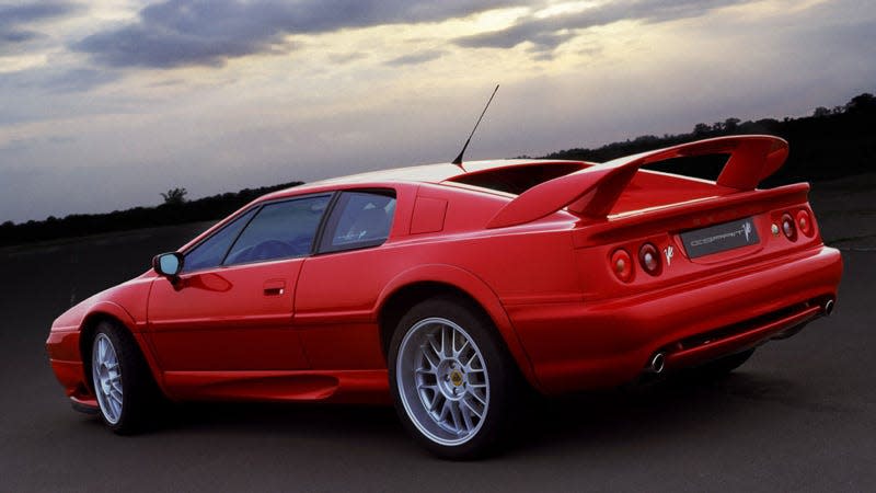 A photo of a red Lotus Esprit sports car at sunset. 