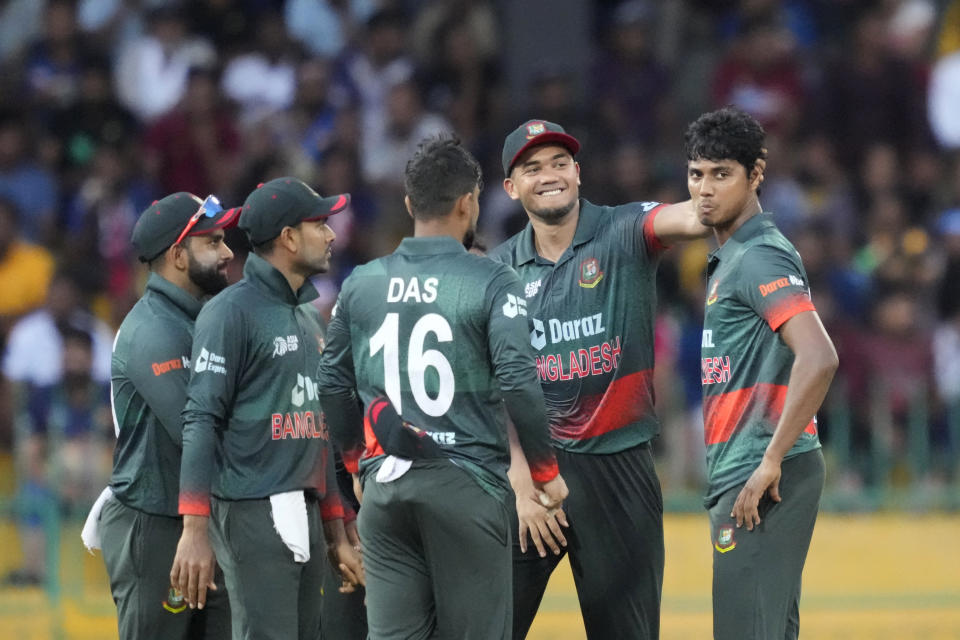 Bangladeshes' team members congratulate Hasan Mahmud, right, for the wicket of Sri Lanka's Dhananjaya de Silva during the Asia Cup cricket match between Sri Lanka and Bangladesh in Colombo, Sri Lanka on Saturday, Sep. 9. (AP Photo/Eranga Jayawardena)