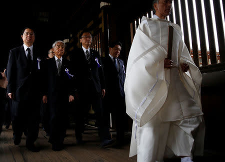 A group of lawmakers including Japan's ruling Liberal Democratic Party (LDP) lawmaker Hidehisa Otsuji (2nd L) are led by a Shinto priest as they visit Yasukuni Shrine in Tokyo, Japan April 21, 2017. REUTERS/Toru Hanai