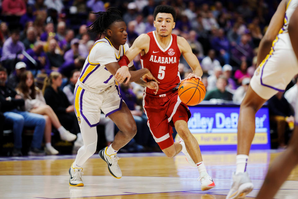 Alabama guard Jahvon Quinerly (5) drives to the basket against LSU guard Cam Hayes (1) during the second half at Pete Maravich Assembly Center.