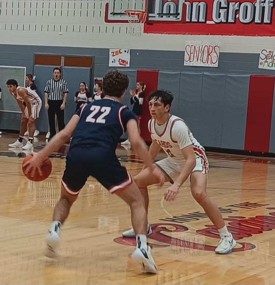 Indian Valley's Ryker Williams (22) is defended by Sandy Valley's Troy Snyder, right, during an Inter Valley Conference boys' basketball game Saturday night in the Cardinals' gymnasium.