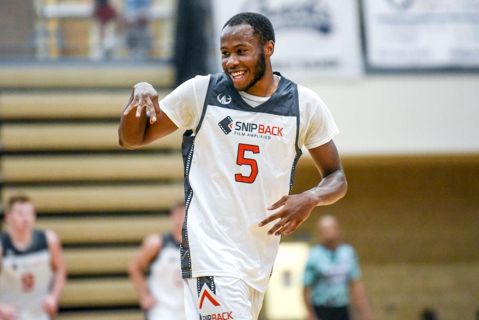 Team Snip Back and Michigan State's Tre Holloman celebrates after his 3-pointer against Team Goodfellas on Thursday, June 29, 2023, during the Moneyball Pro-Am at Holt High School.